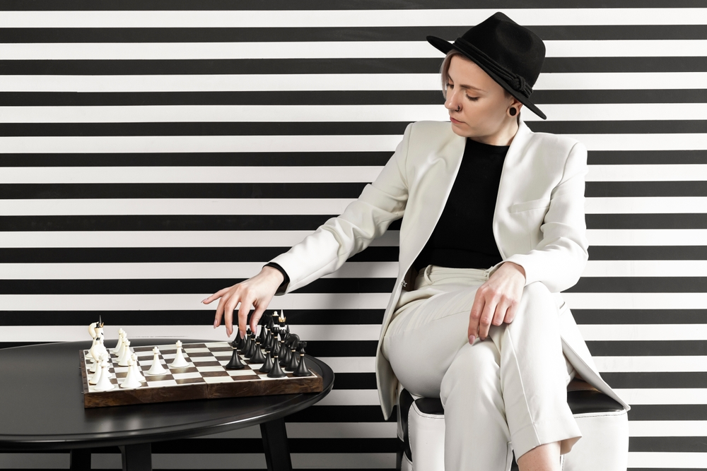 A Women Playing Chess inWhite Blazer Outfit